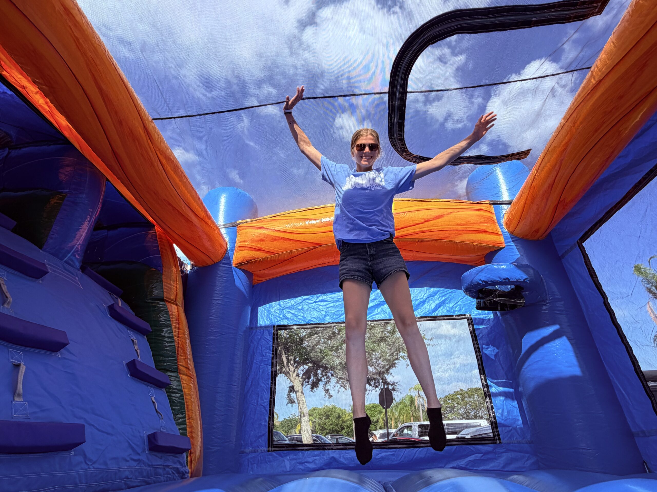 Kids jumping in bounce house water slide combo rental for 4th of July party Palm Beach County FL