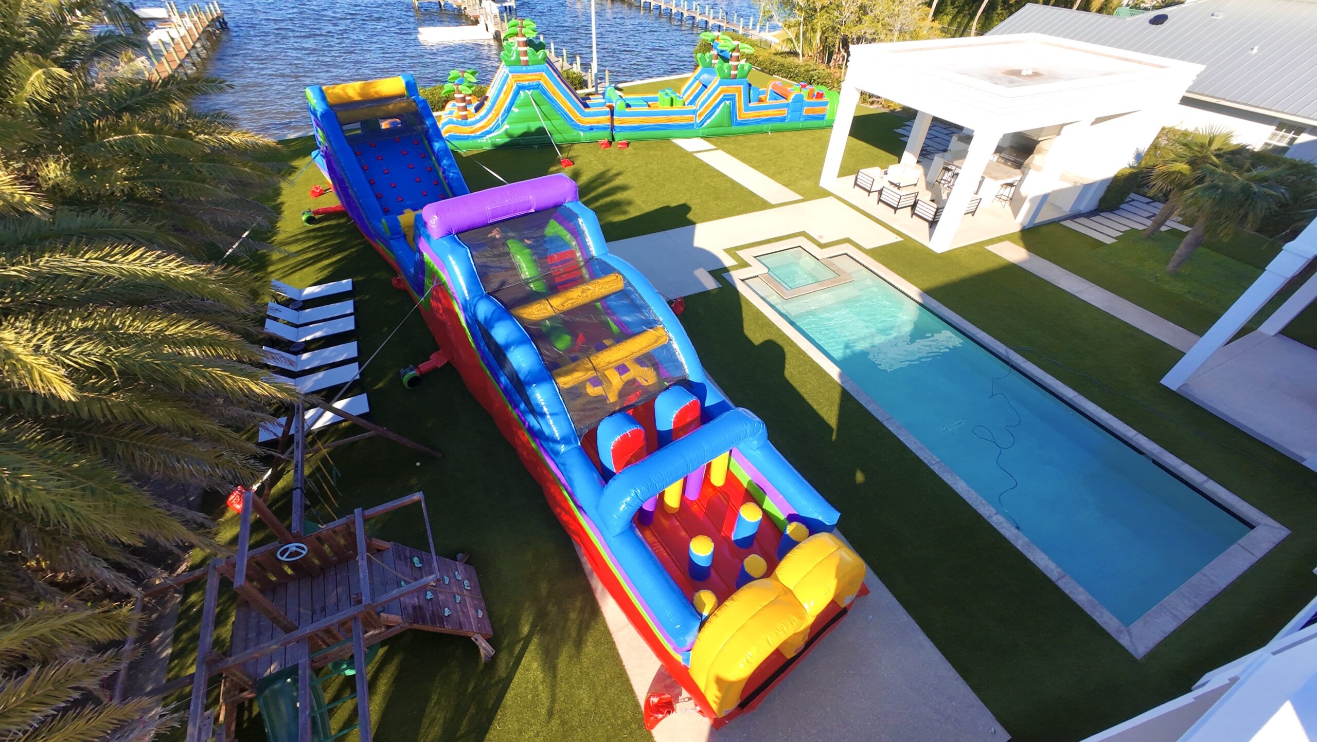 Two inflatable obstacle courses set up for a Halloween party in a Palm Beach County backyard