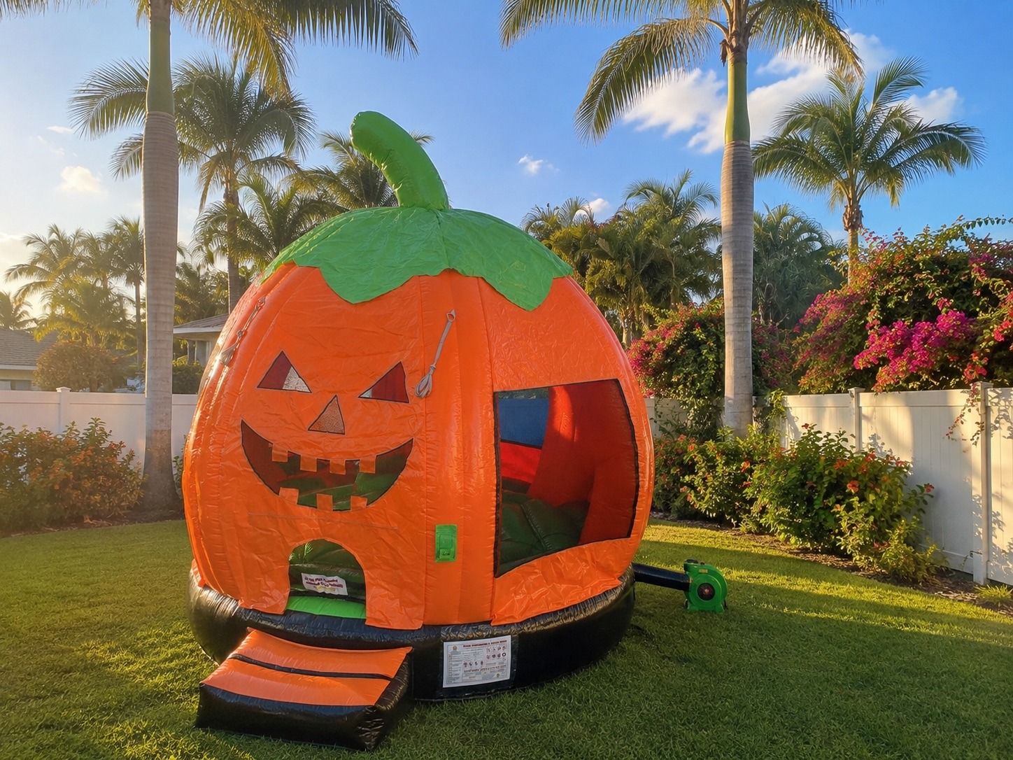Pumpkin-themed bounce house rental set up at a fall festival in Palm Beach County